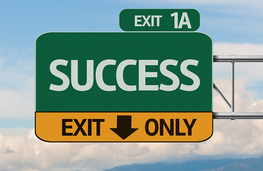 Highway exit sign pointing toward Success
