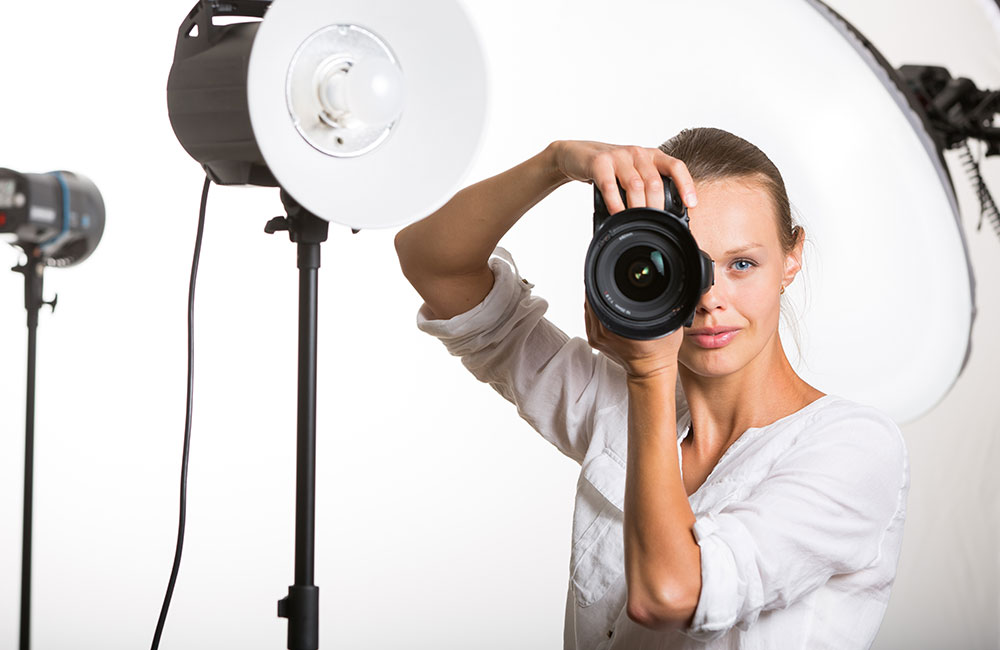 A photographer shoots photos in her photo studio