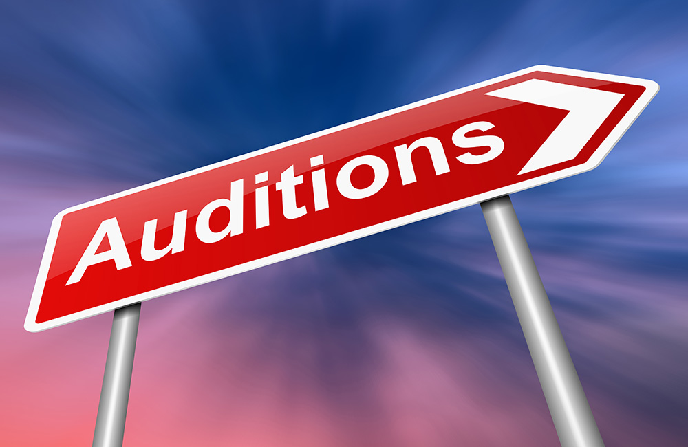 A road sign pointing to Auditions