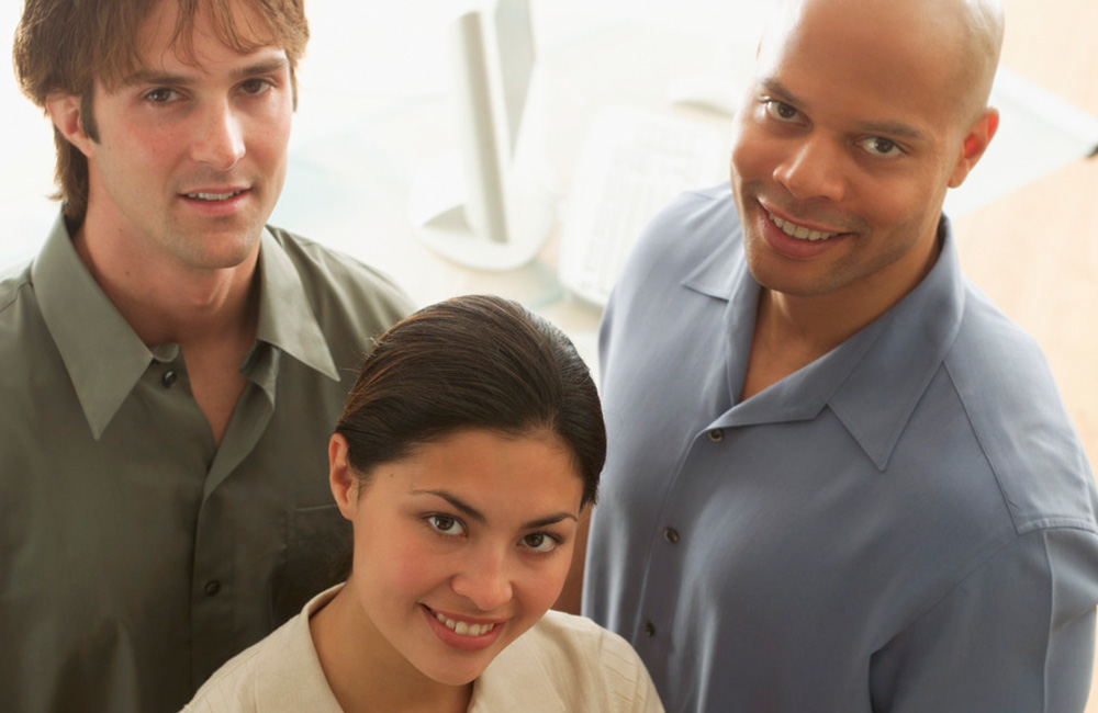 A diverse group of adults looking happy