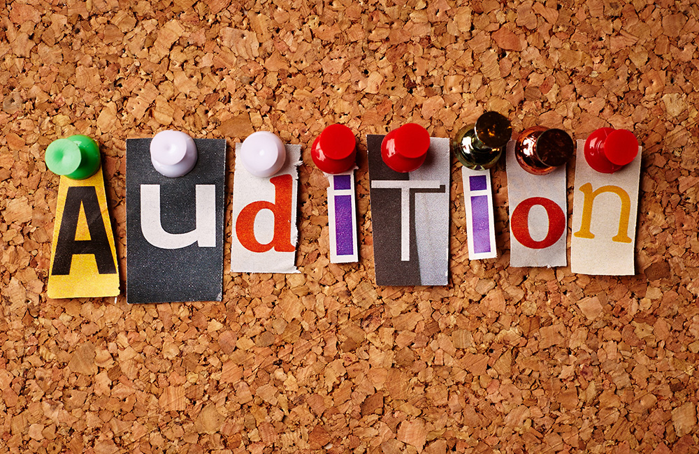 Letters spelling Audition on a corkboard