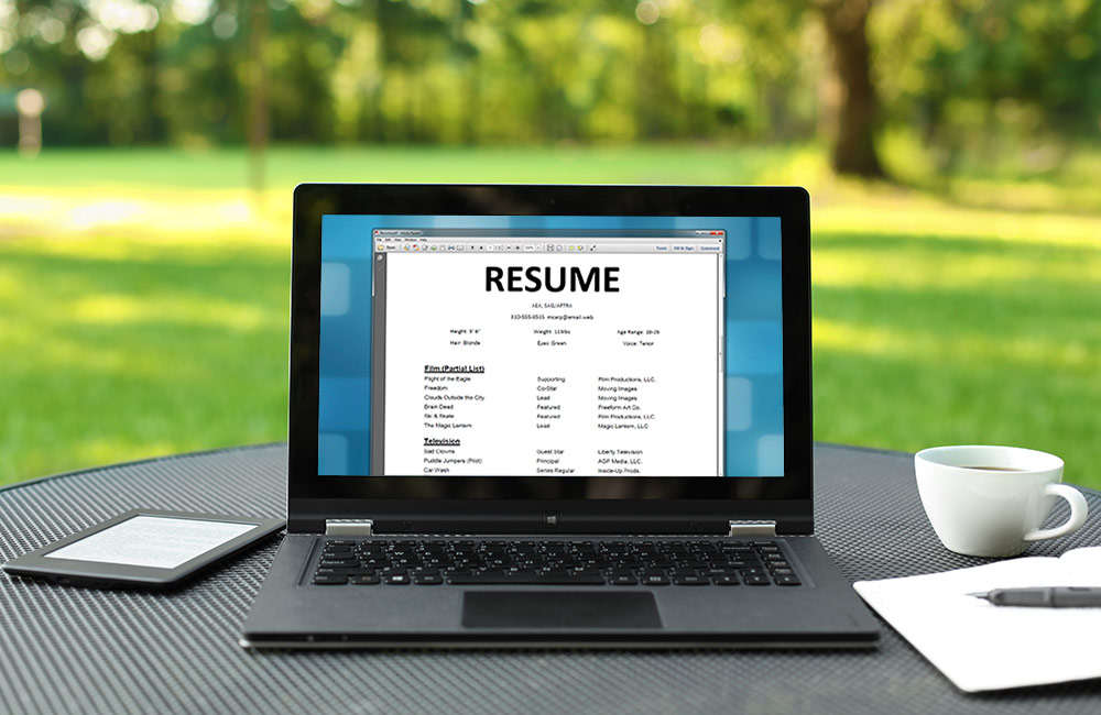 A laptop screen shows a resume word document