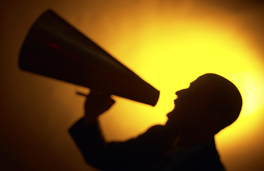 A man shouts into a megaphone