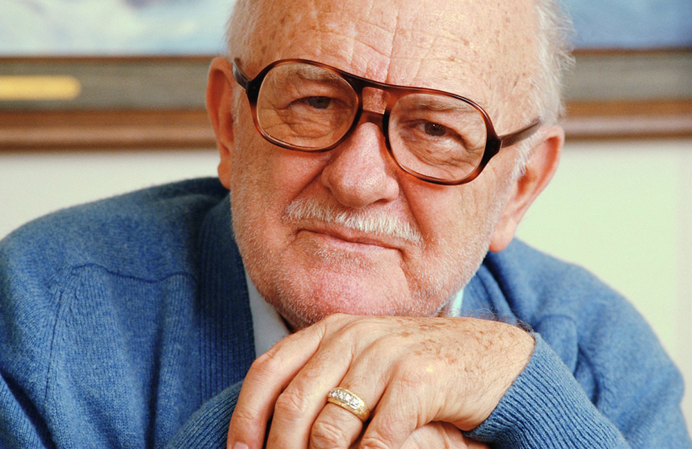 An elderly male actor sits peacefully