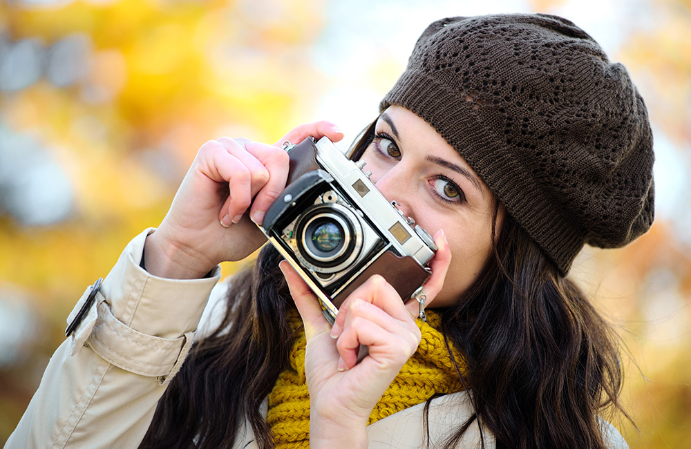 A female photographer holding a camera